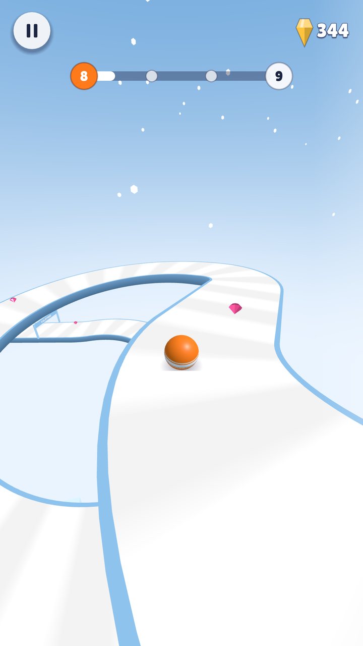 The ball rolling along a snowy road while snowflakes fall